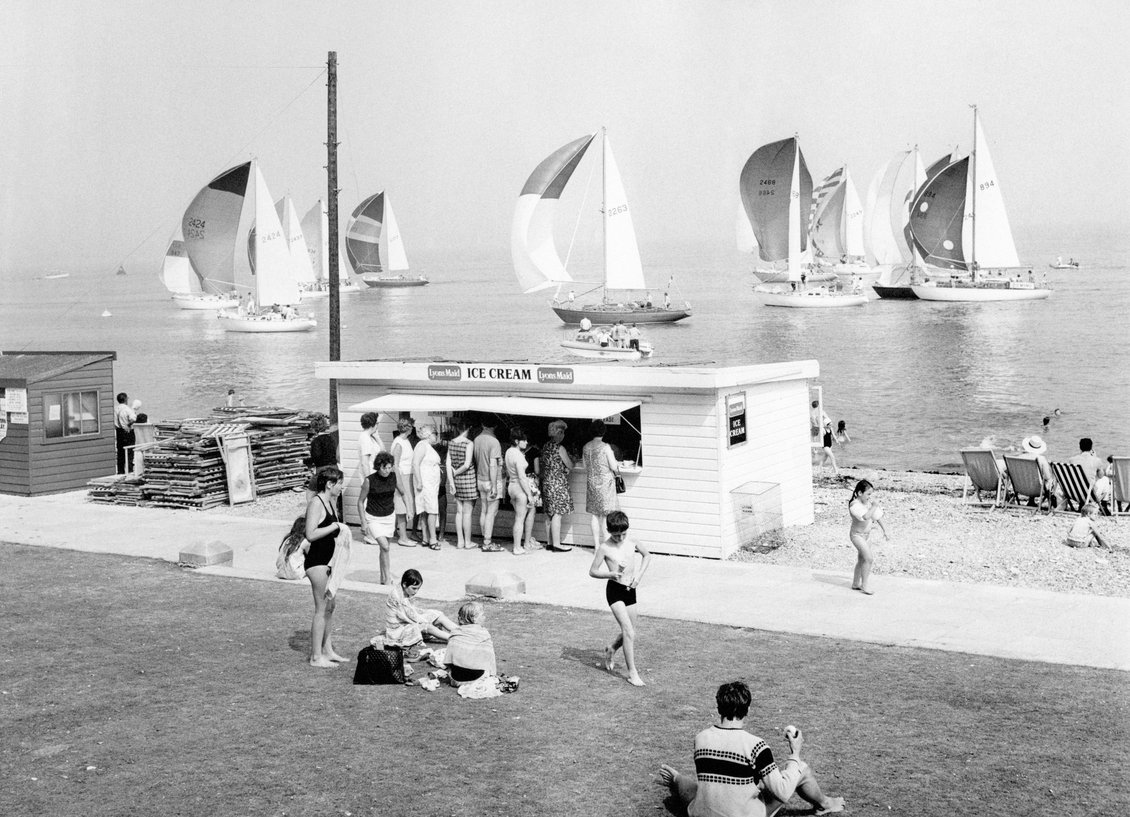Holidaymakers queue up to buy ice cream on a hot summer's day at Cowes on the Isle of Wight.