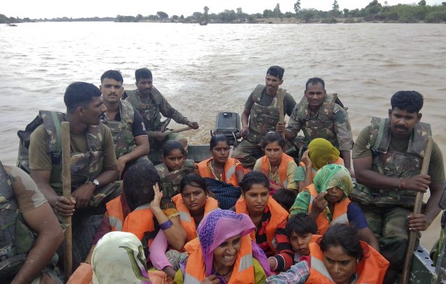 Indian army soldiers rescue flood-affected villagers near Shihori in Banaskantha district, Gujarat (Ajit Solanki/AP/PA)