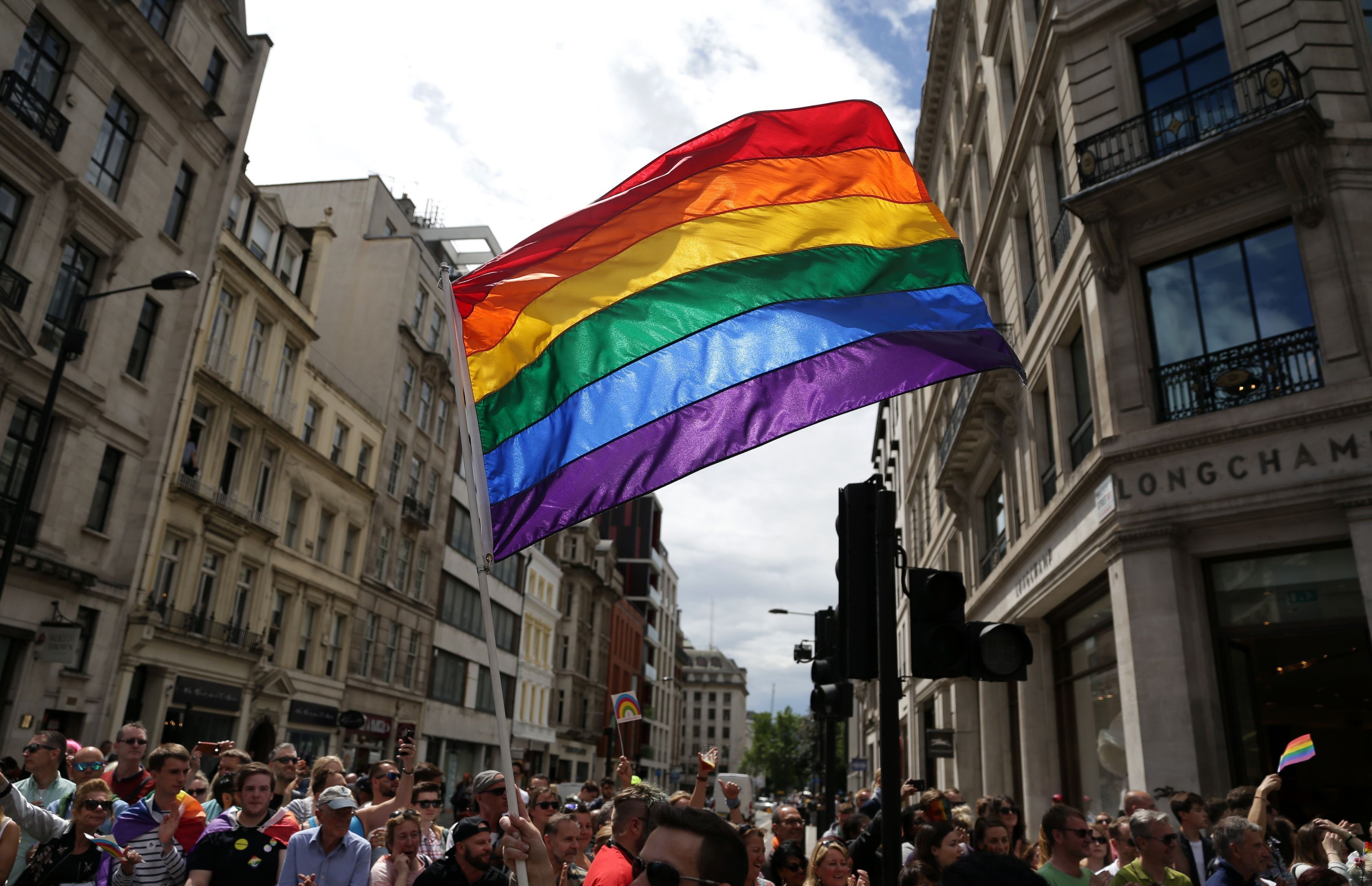 File photo dated 25/06/16 of a rainbow flag held aloft during the Pride in London parade. Theresa May acknowledged that people may be sceptical about the Tory record on gay rights, but insisted that both she and the party had "come a long way" on the issue.