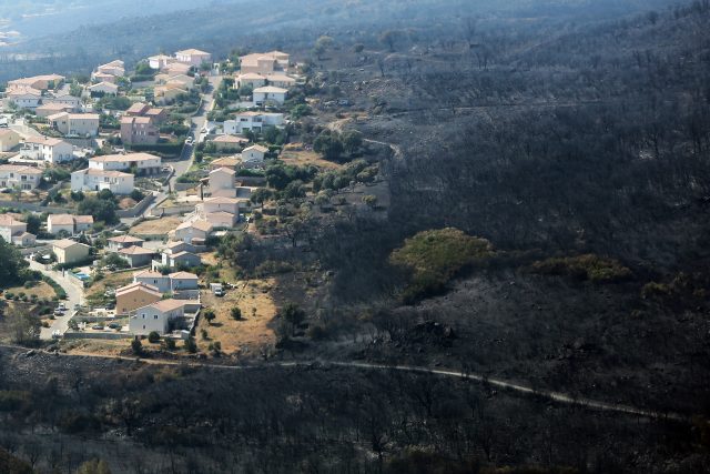 An aerial view shows houses adjacent to terrain scorched by wildfire near the village of Biguglia, Corsica (Raphael Poletti/AP)