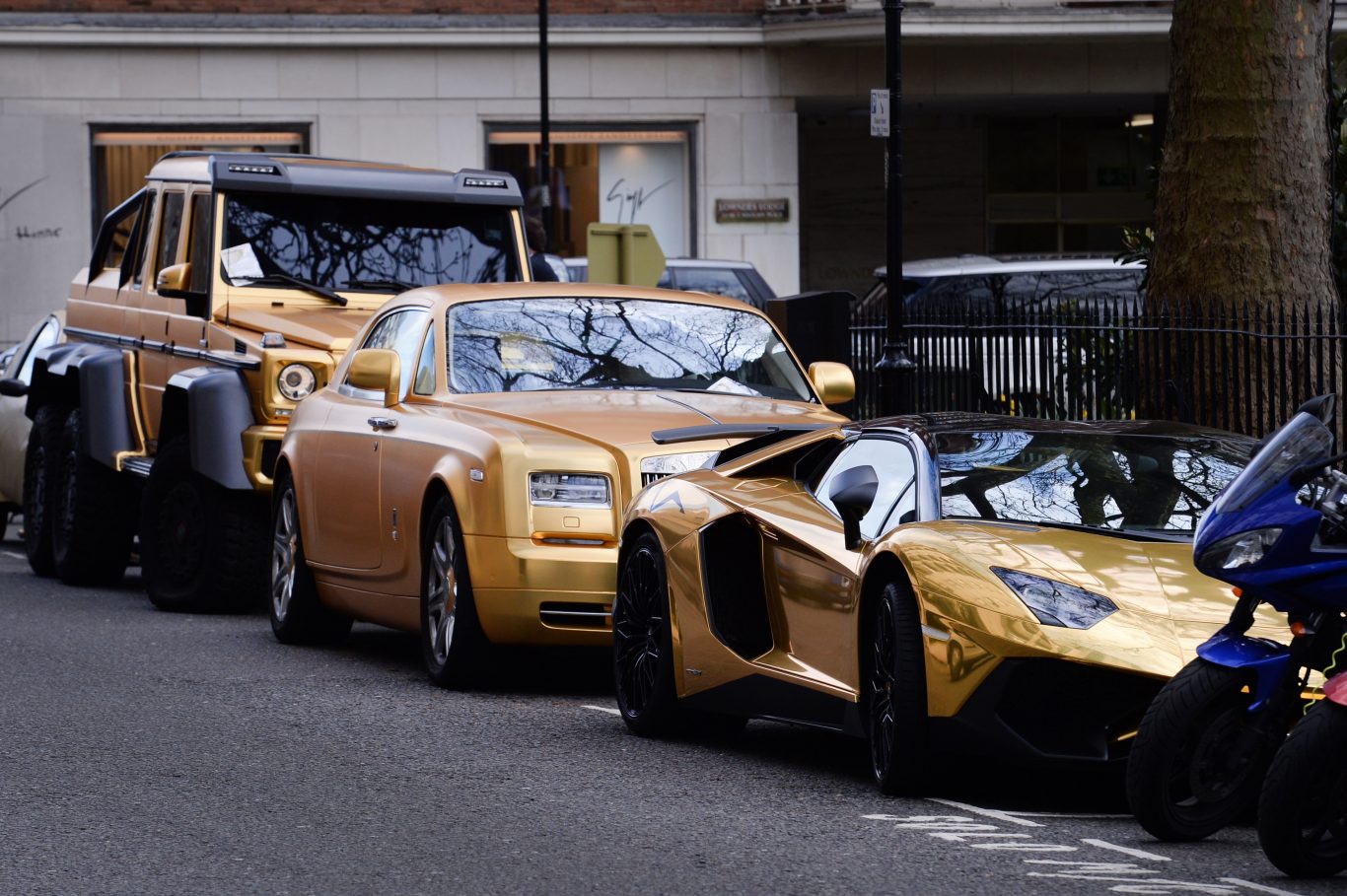 Three gold cars from Saudi Arabia with parking tickets in Knightsbridge (Stefan Rousseau/PA)