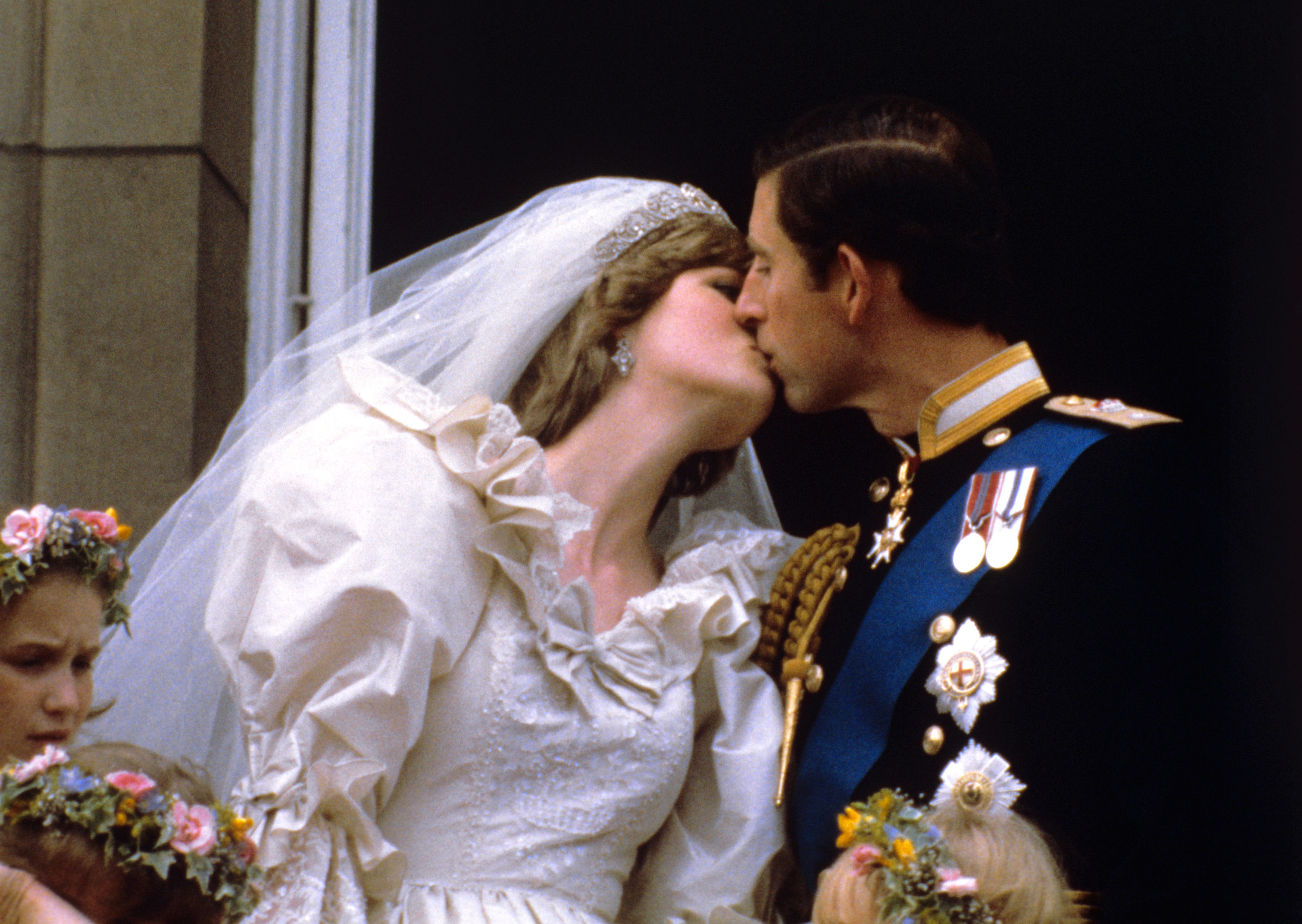 The Prince and Princess of Wales kissing on the balcony of Buckingham Palace, London, after their wedding (PA)