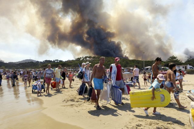 Sunbathers are evacuated from the beach in Le Lavandou, French Riviera