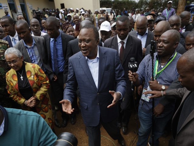 President Kenyatta greets supporters after casting his vote (Ben Curtis/AP)