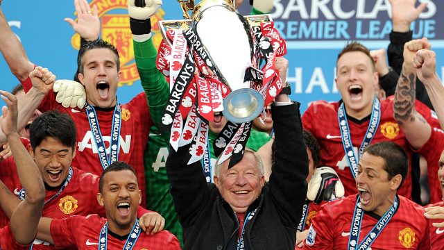 Sir Alex Ferguson lifting the Barclays Premier League trophy in 2013 (Martin Rickett/PA)