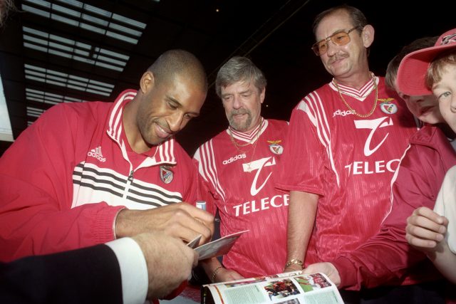 Brian Deane signs autographs during his stint at Benfica (PA)