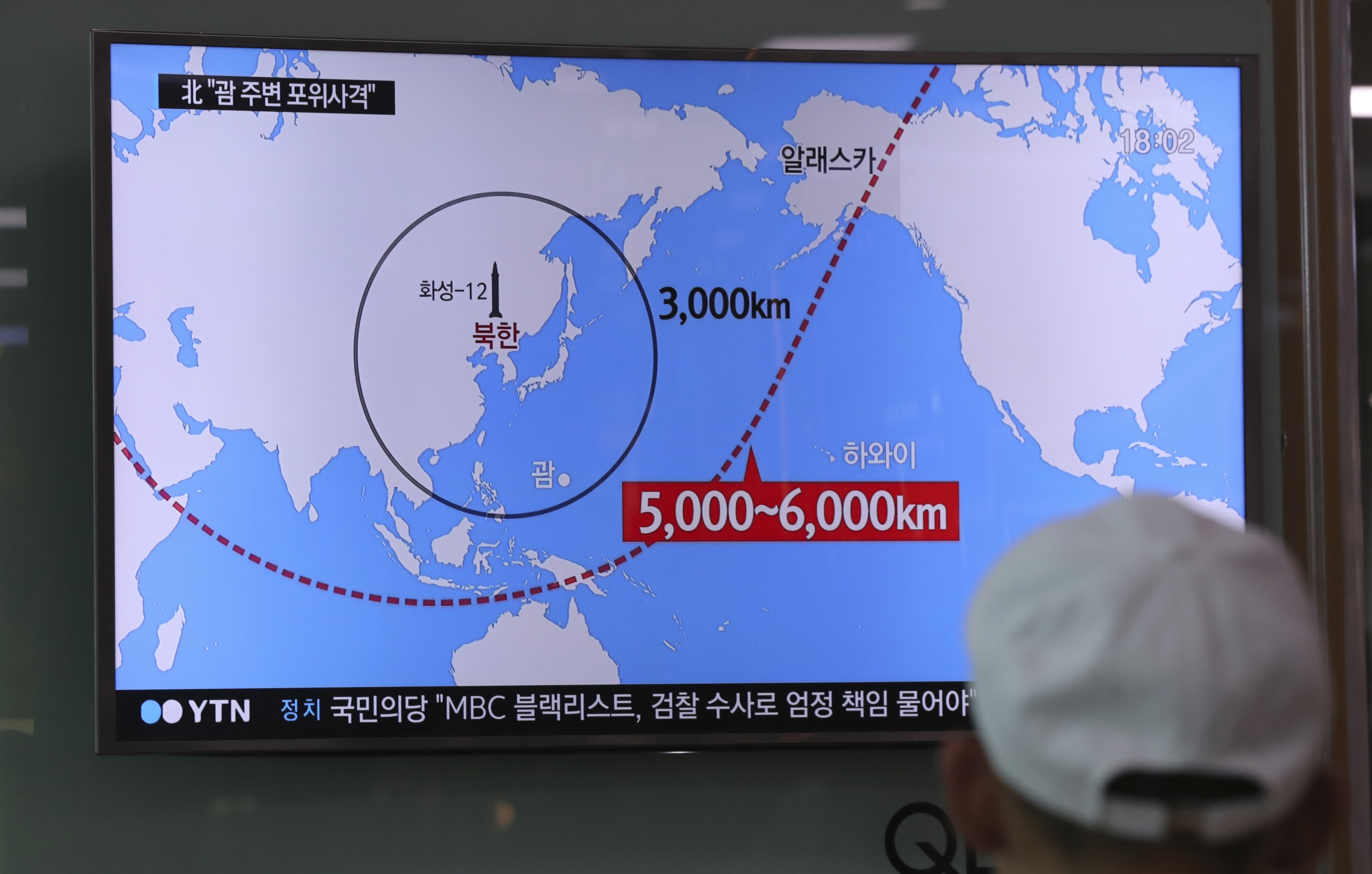 A man watches a TV screen showing a local news program reporting on North Korea's missiles at the Seoul Train Station in Seoul, South Korea, Wednesday, Aug. 9, 2017. Donald Trump’s threat to unleash “fire and fury” on North Korea might have been written by Pyongyang’s propaganda mavens, so perfectly does it fit the North’s cherished claim that it is a victim of American aggression. (AP Photo/Lee Jin-man)