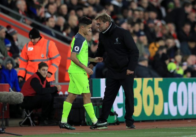 Jurgen Klopp, right, speaks to Philippe Coutinho during the EFL Cup semi-final at Southampton