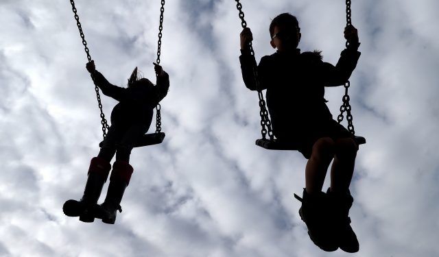 Children play on swings