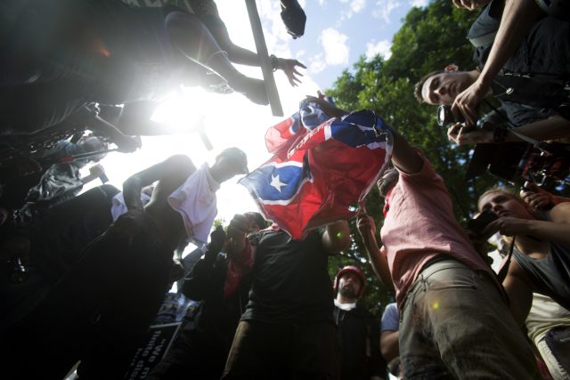Counter-protesters tear a Confederate flag during the white nationalist rally on Saturday in Charlottesville 
