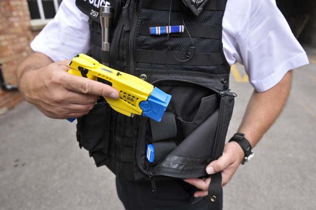A police officer holstering a Taser during a training exercise
