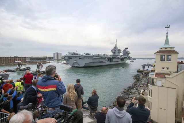 Crowds watch as HMS Queen Elizabeth, the UK's newest aircraft carrier, arrives in Portsmouth