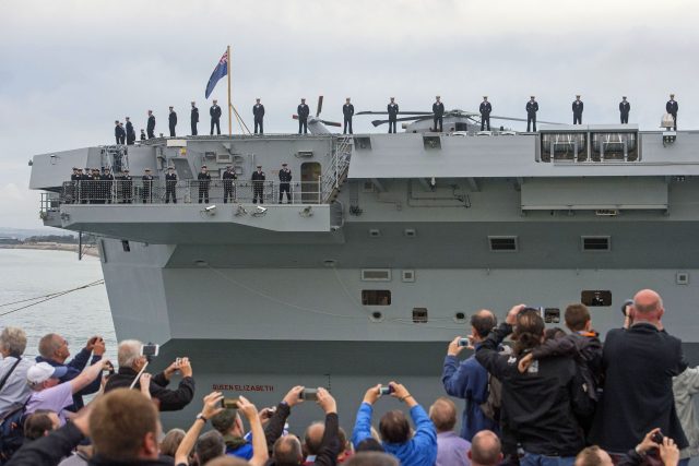 Crowds watch as HMS Queen Elizabeth, the UK's newest aircraft carrier, arrives in Portsmouth