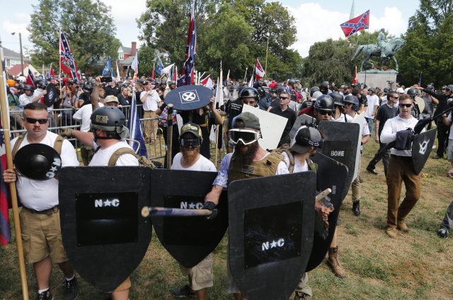 White nationalist demonstrators holding their ground as they clash with counter demonstrators in Lee Park in Charlottesville