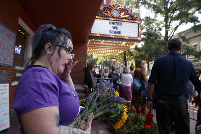 Cynthia Sullivan of Charlottesville stands in line for a memorial service for Heather Heyer