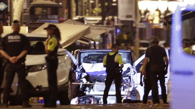 Police patrol the scene of the terrorist attack in Barcelona with the damage to the van clear to see