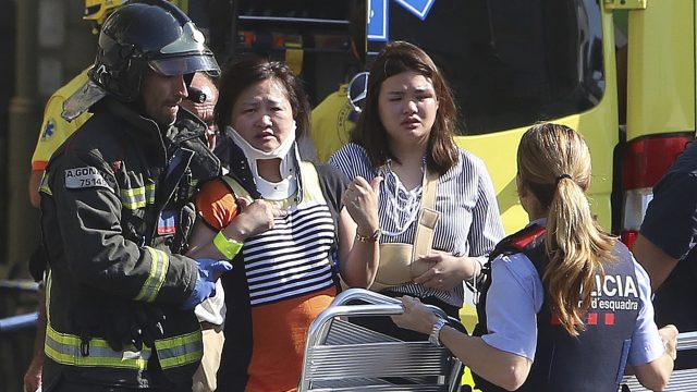 The injured are treated by medics at the scene of the terror attack in Barcelona