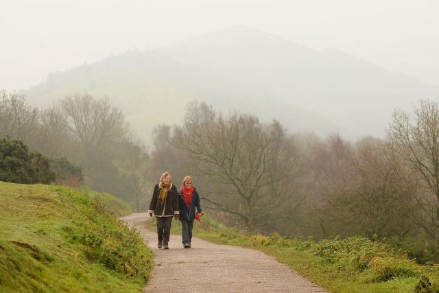 People take an early morning walk along the Malvern Hills in Worcestershire
