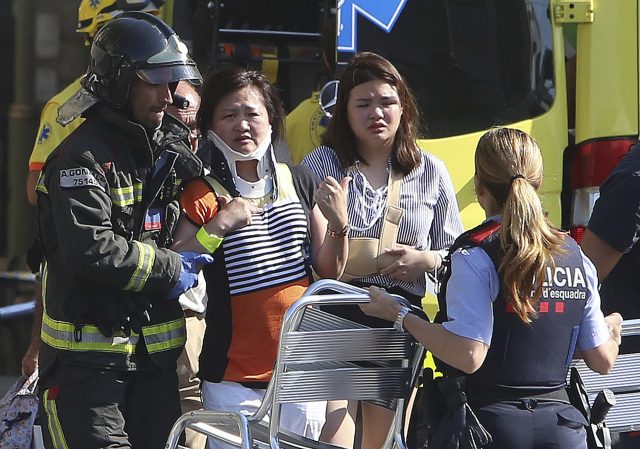 Injured people are treated in Barcelona after a terror attack