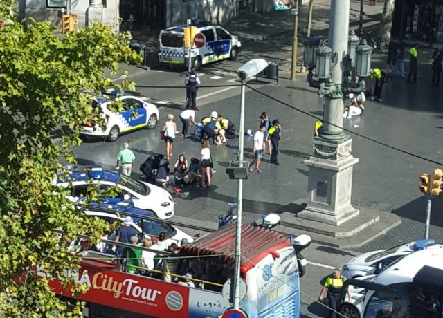 Injured people are helped after a terror attack in Barcelona