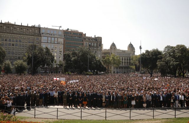 People, along with King Felipe of Spain, PM Mariano Rajoy and Catalonia regional president Carles Puigdemont observe a minute of silence in Las Ramblas