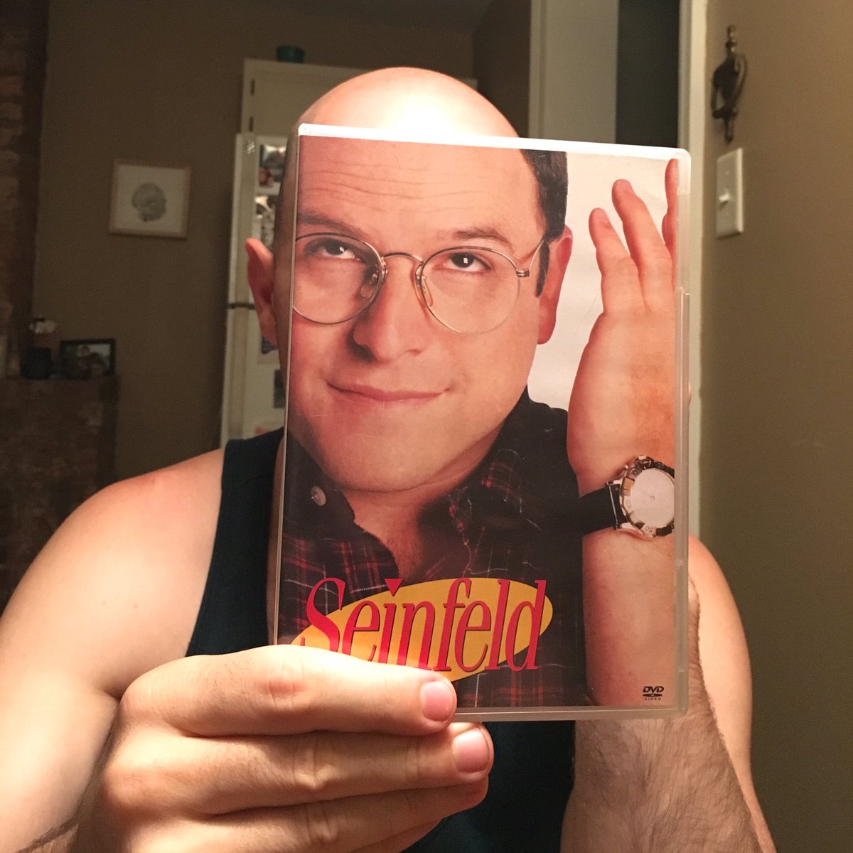Ben O'Brien poses with the Seinfeld DVD sleeve as though he is George (Ben O'Brien/Kelly Lasserre/Twitter)