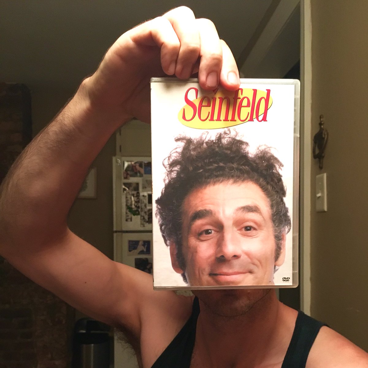 Ben O'Brien poses with the Seinfeld DVD sleeve as though he is Kramer (Ben O'Brien/Kelly Lasserre/Twitter)