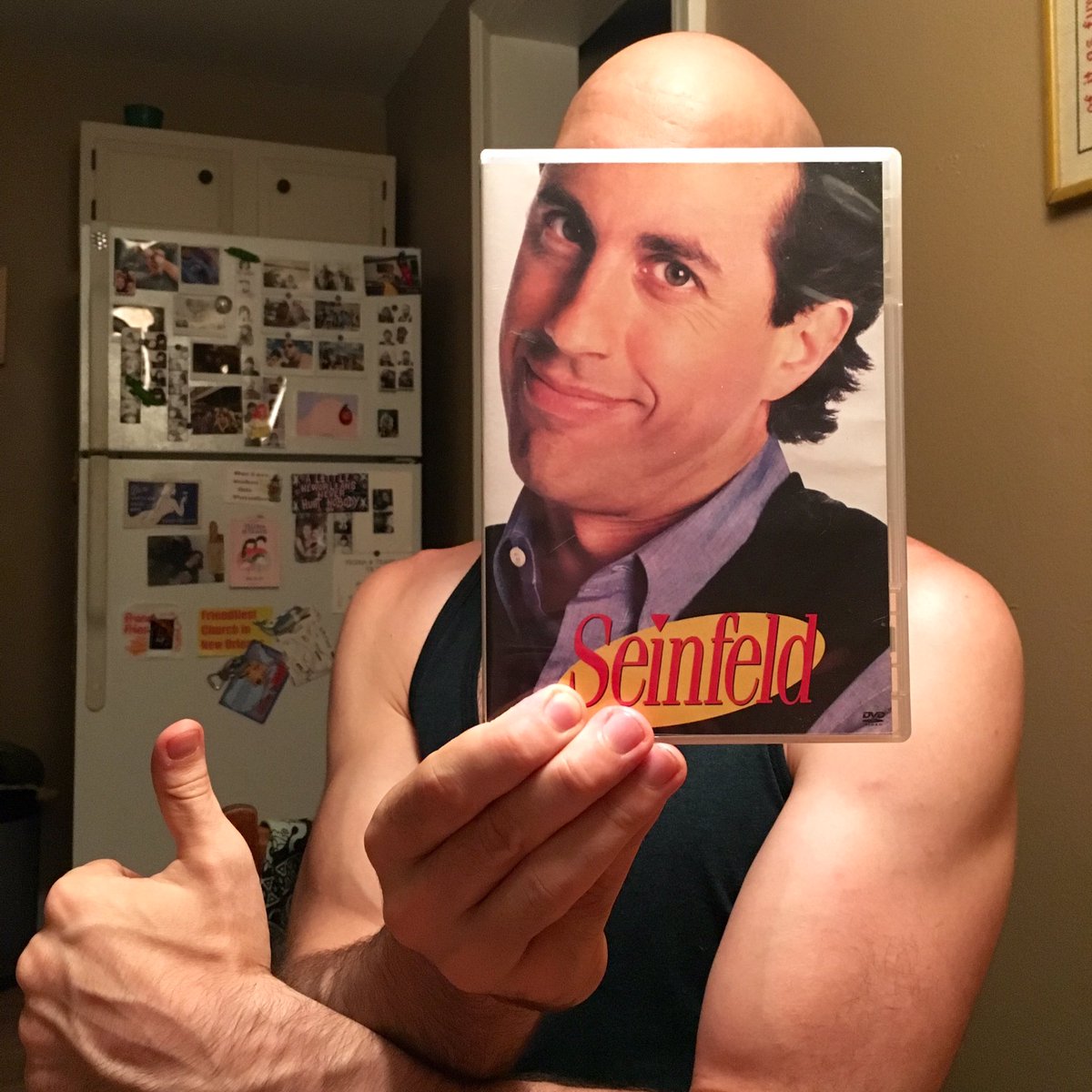Ben O'Brien poses with the Seinfeld DVD sleeve as though he is Seinfeld (Ben O'Brien/Kelly Lasserre/Twitter)