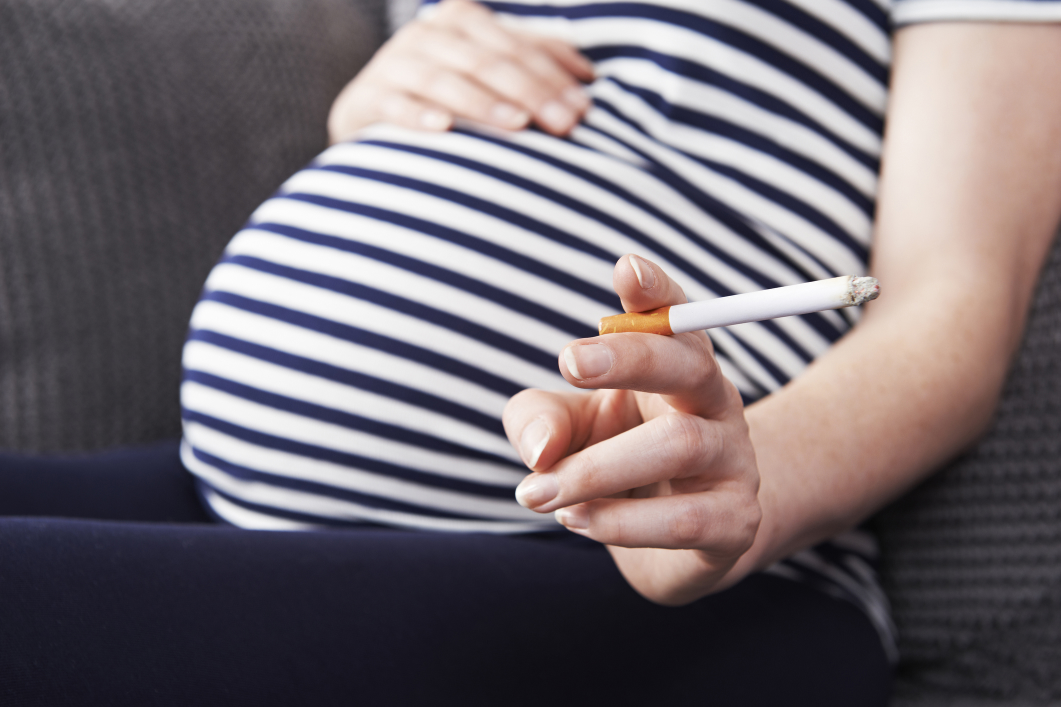 Pregnant woman smoking.