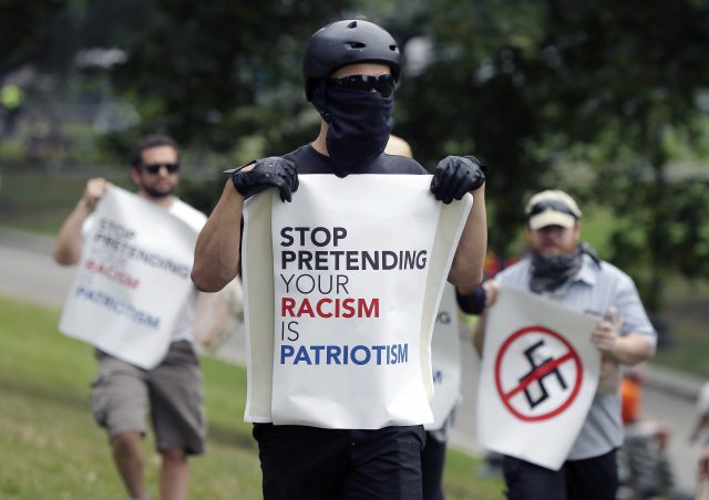 Counter-protesters hold signs at the 