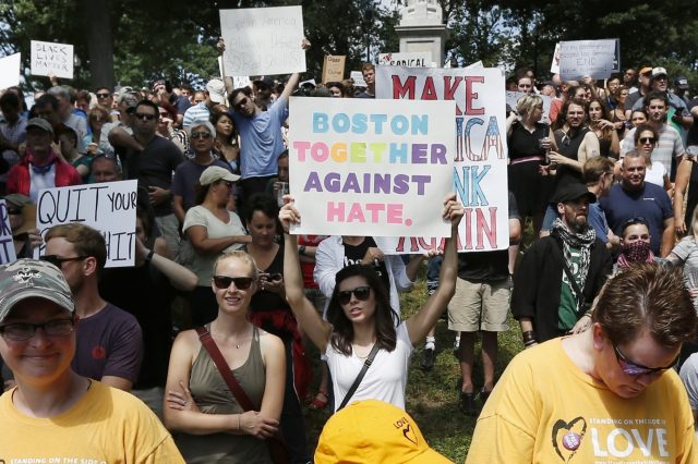 Counterprotesters hold signs at the free speech rally (Michael Dwyer/AP)