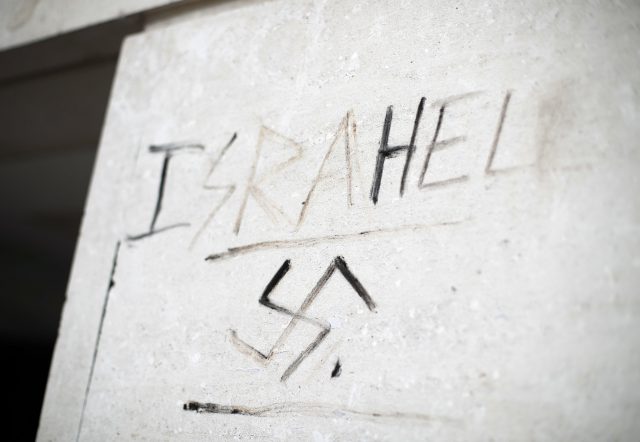 Anti-Israel graffiti next to a swastika on a wall in Victoria, London (Yui Mok/PA)