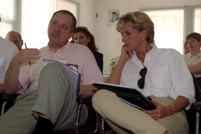 Diana listens to a briefing on the work of the British Red Cross in Angola on a trip in 1997