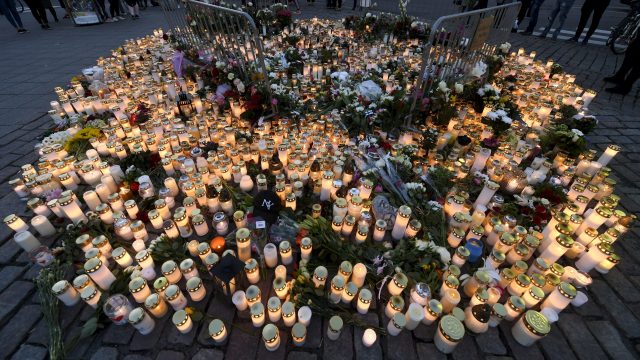 A memorial of candles are placed at the scene of the stabbing attack at the Turku Market Square