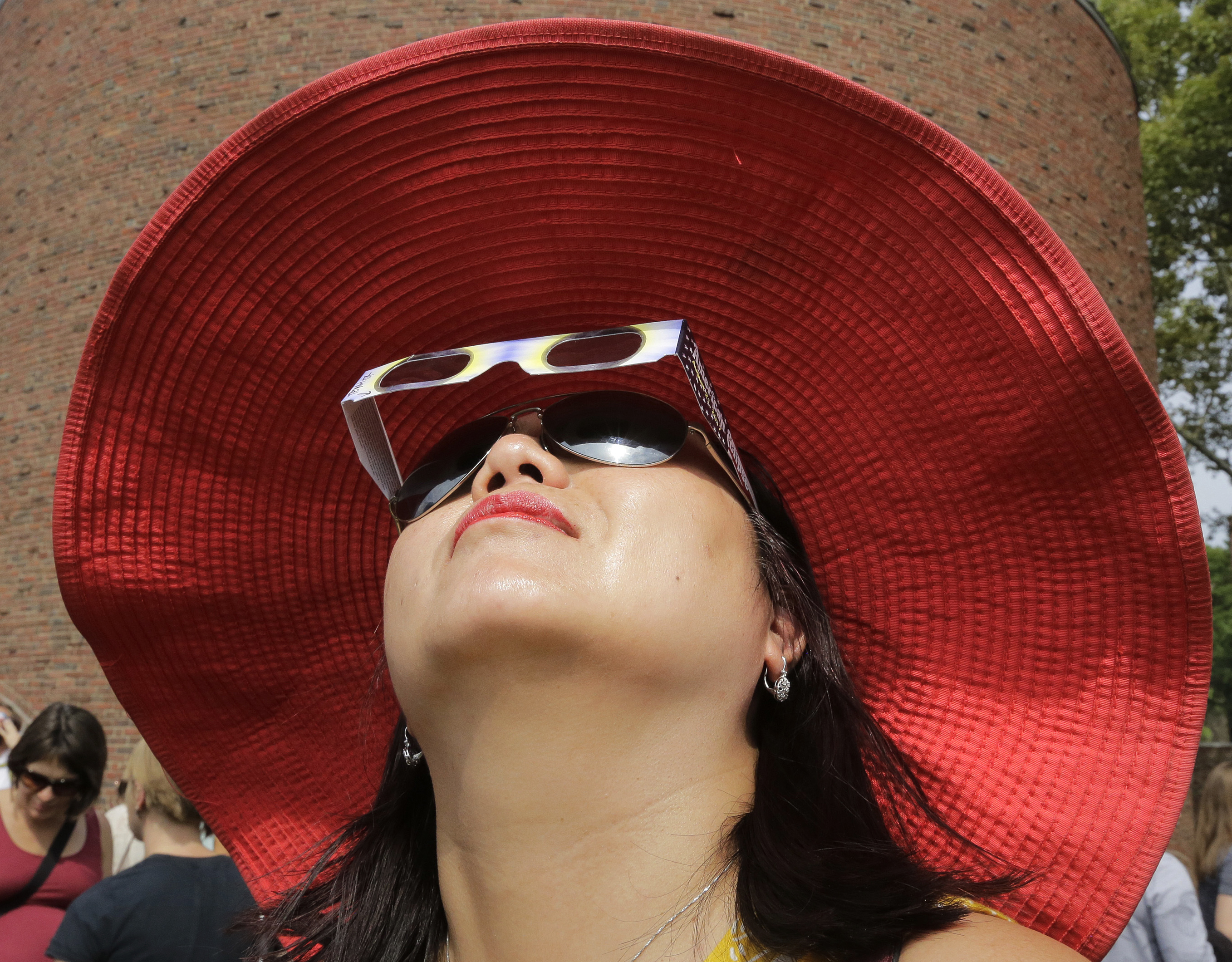 Someone uses protective glasses to view the solar eclipse