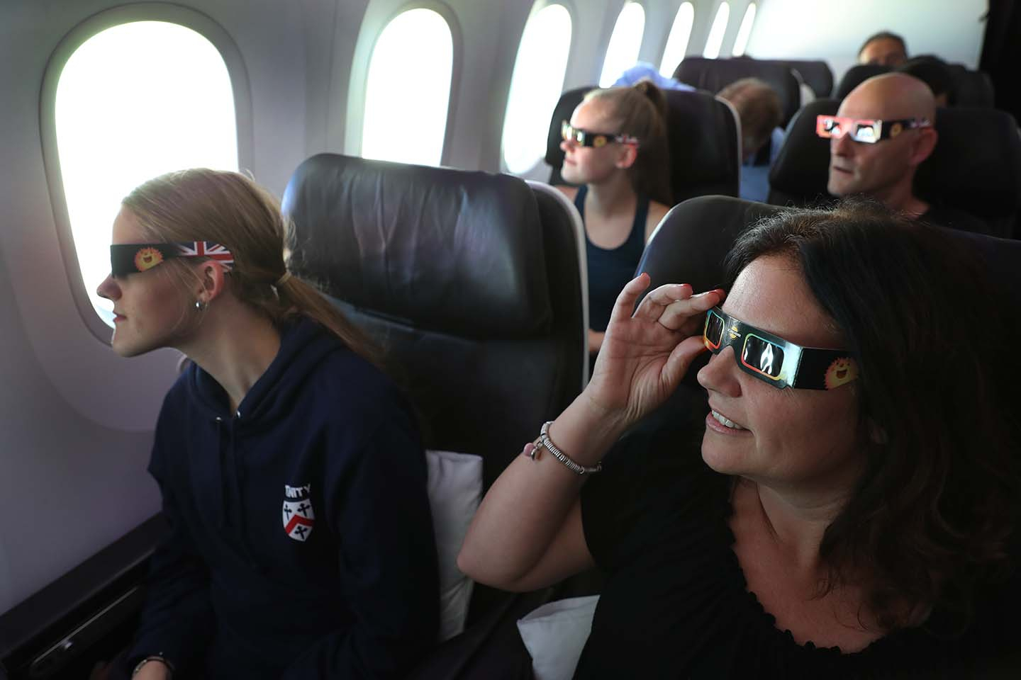 Passengers watch the start of the solar eclipse while flying over the United States