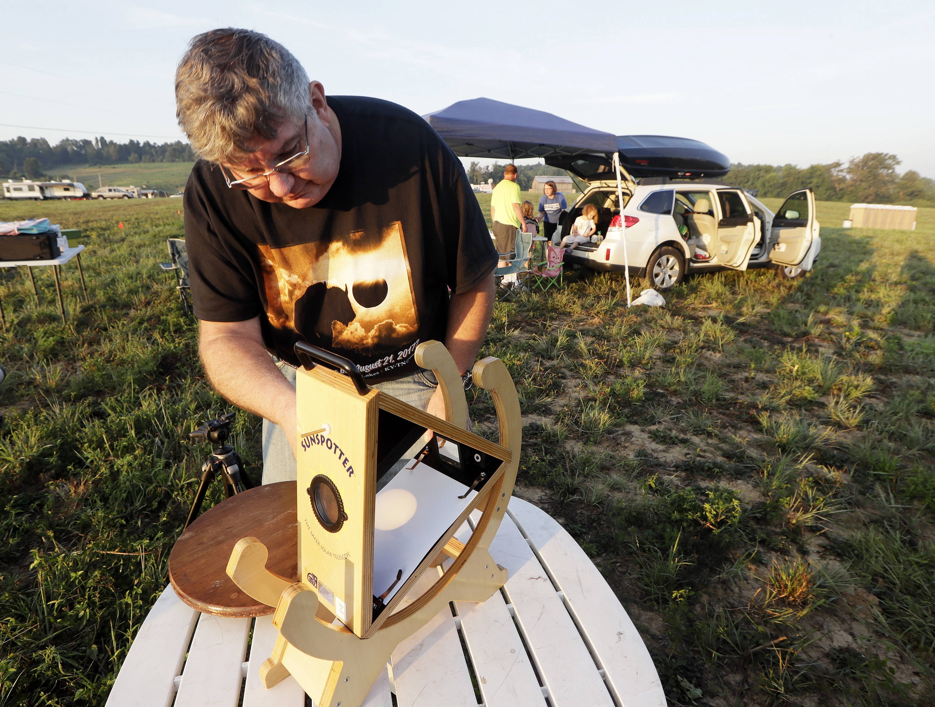 Someone sets up a Sunspotter, a device for viewing the solar eclipse