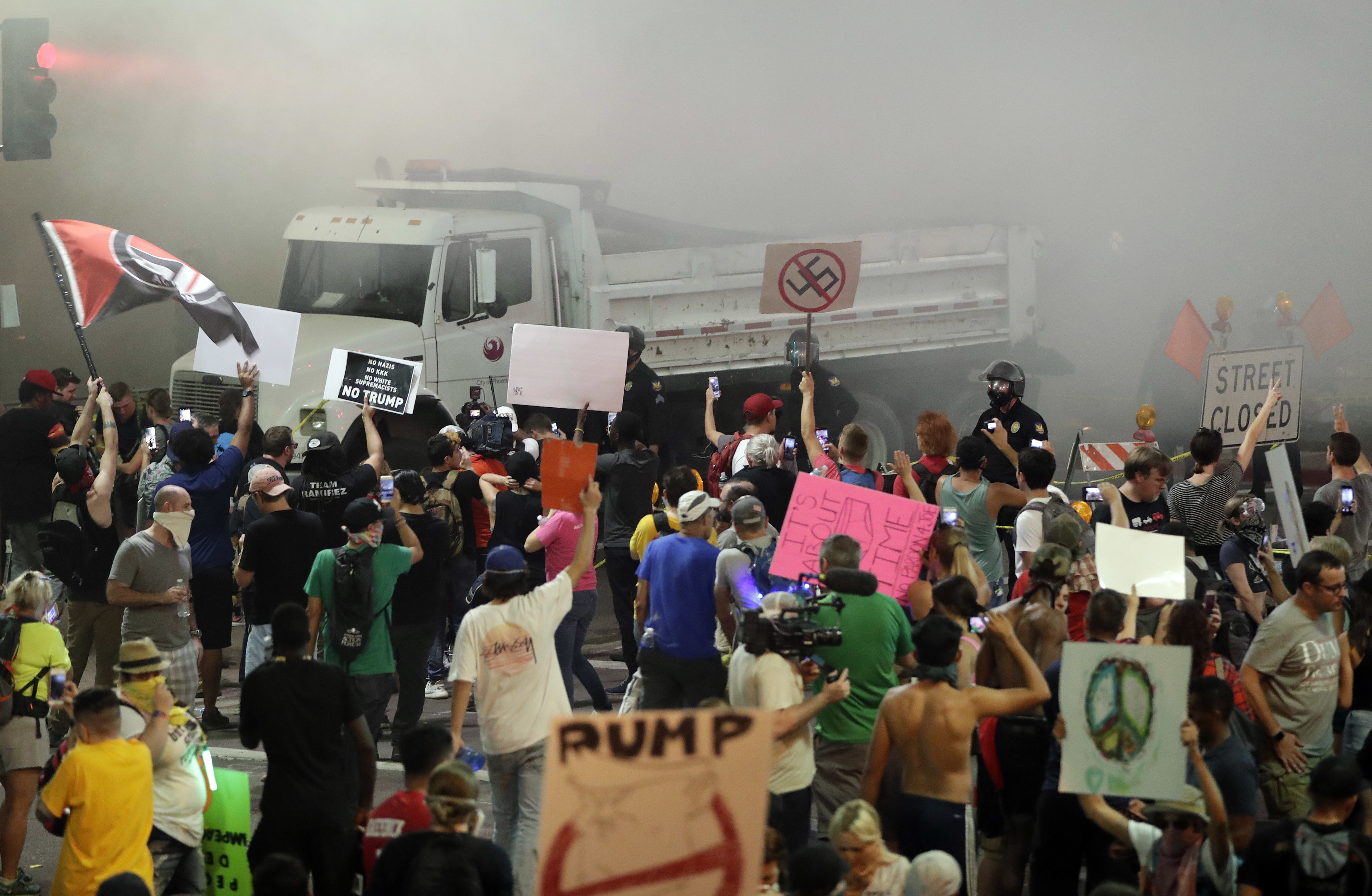 Protesters yell after Phoenix police used tear gas