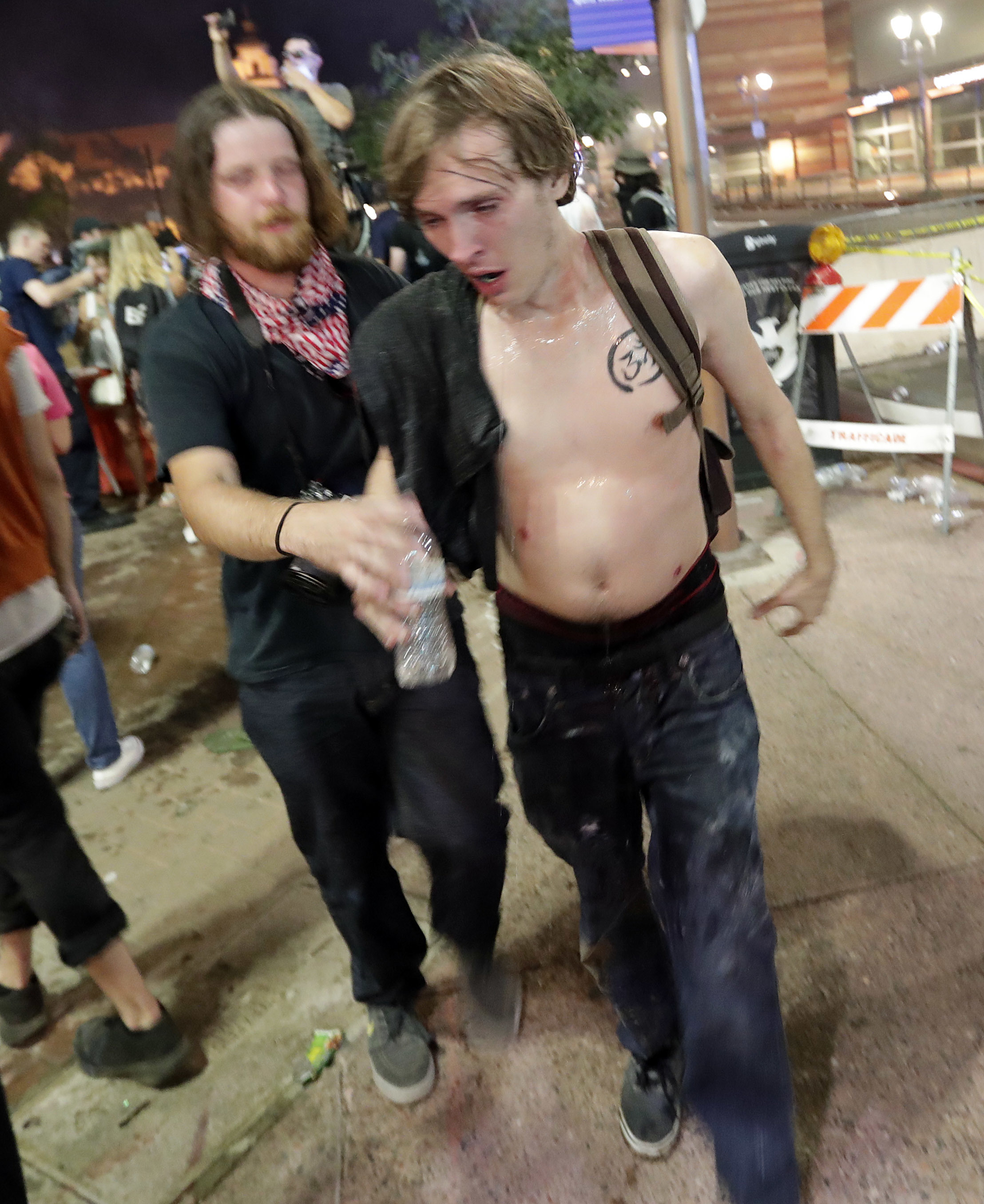 Protesters leave the scene after Phoenix police used tear gas 