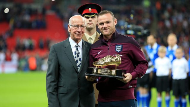 Sir Bobby Charlton presents England's Wayne Rooney with a golden boot to commemorate him becoming his country's all-time leading goalscorer