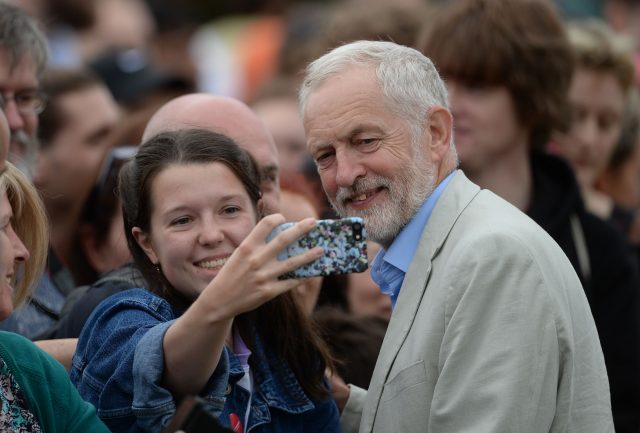 Labour leader Jeremy Corbyn poses for a selfie during a rally 