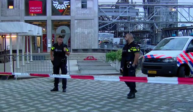 Officers stand behind a cordoned-off area in Rotterdam