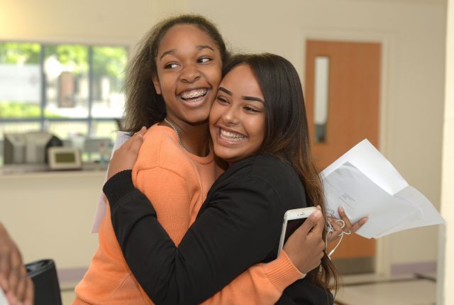 Elise Mouricette-Johnson (left) and Jerusalem Benyam celebrate after collecting their GCSE results, at Sion-Manning Roman Catholic Girls school in west London