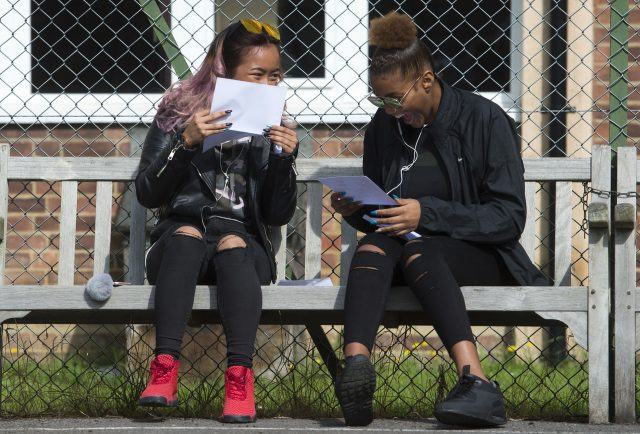 Nadiyah Harto, left, and Jackie Da Silva celebrate after collecting their GCSE results, at Sion-Manning Roman Catholic Girls school in west London