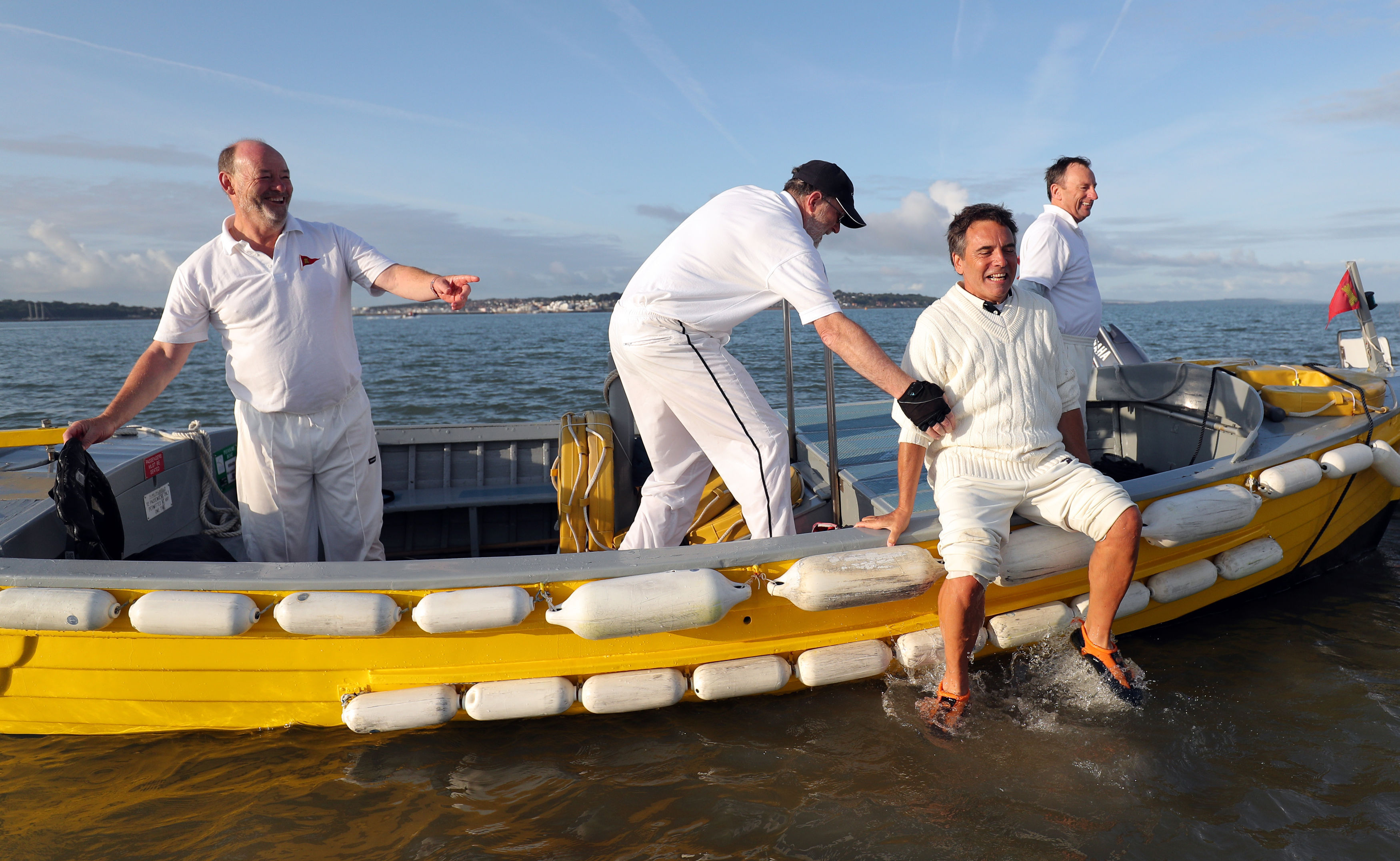 Cricket players on a boat after the annual Brambles cricket match