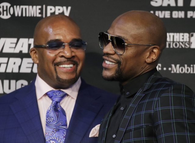 Leonard Ellerbe and Floyd Mayweather speaking at a press conference