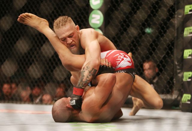 McGregor fighting Diego Brandao in 2014 (Brian Lawless/PA)