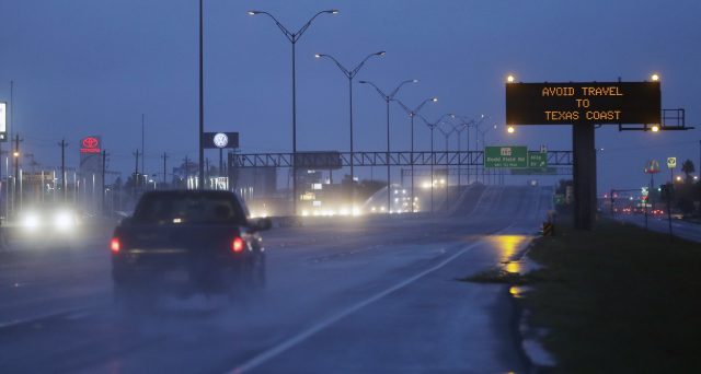 Motorists pass a warning sign in Corpus Christi, Texas (Eric Gay/AP)