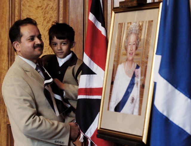 Muhammad Massood and son Mohsi at a special citizenship ceremony in Glasgow. (Andrew Milligan/PA)