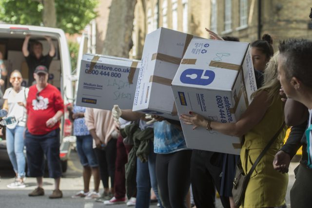 Volunteers organise boxes of donations after the Grenfell Tower fire (David Mirzoeff/PA)